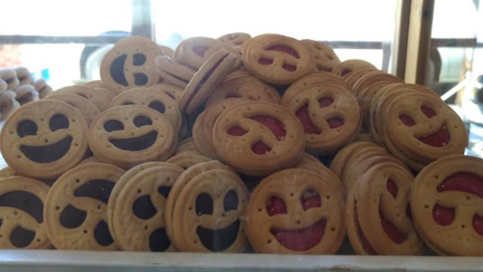 Assorted smiley-face filled biscuits at Santa Irini Bakery